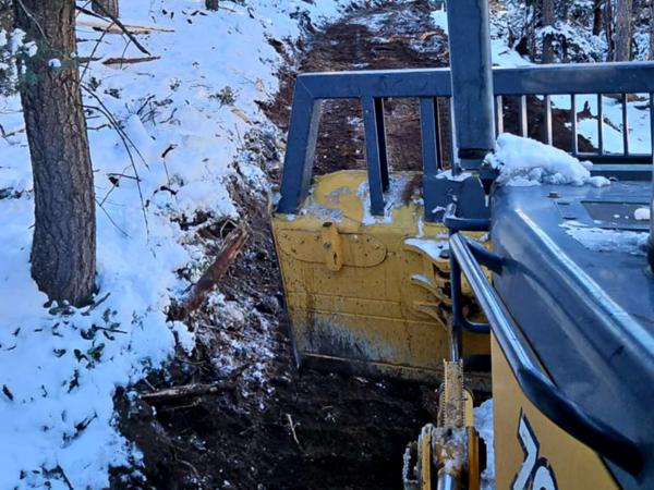 Snow can't stop us for cutting a new road by Chaparral Construction